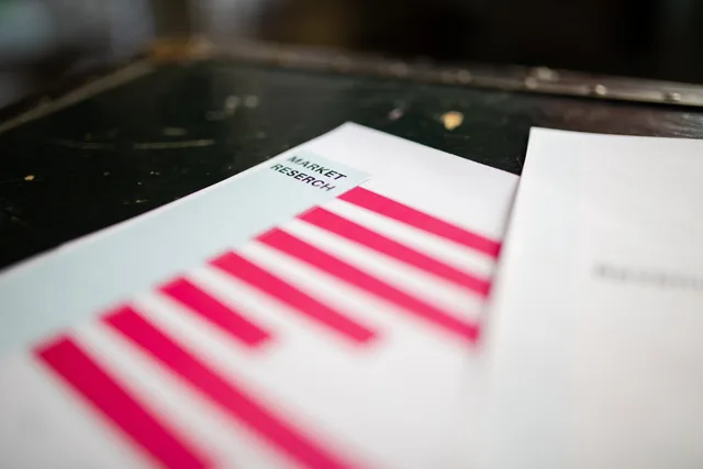 A detailed close-up of a market research document featuring a bar graph and a focus on market trends. Where B2B influencer marketing benchmark data sits and how to judge it
