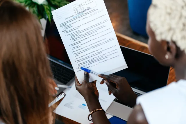 From above of crop anonymous business colleagues working with important documents while discussing strategy in office. When to compare B2B influencer marketing providers: Onalytica, Traackr, Upfluence and more