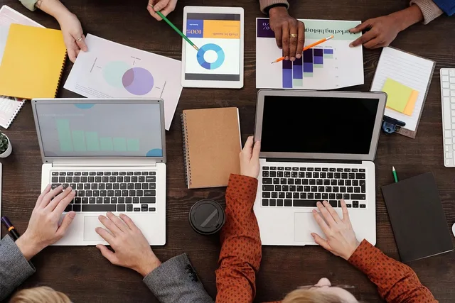 work meeting, notebook, charts, report, work desk, office, collaboration, ideas, discussion, planning, writing, teamwork, smart device, office tools, contemporary, business analysis, data, office paper, table. How to read B2B influencer marketing demand signals