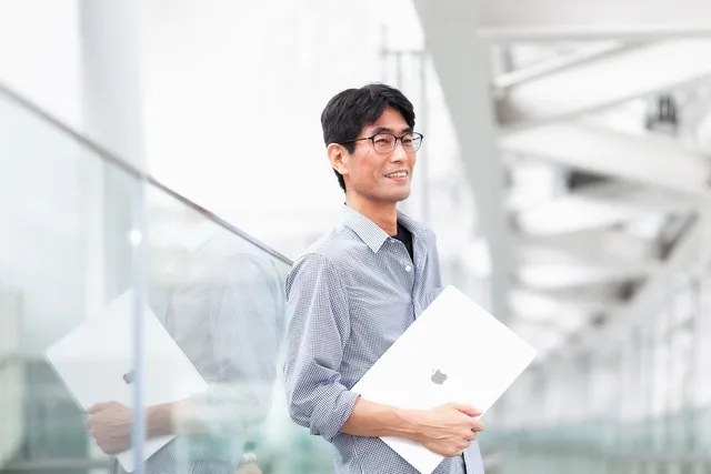 man, laptop, glasses, professional, smile, office, corporate. What does a B2B influencer marketing strategy look like in practice?